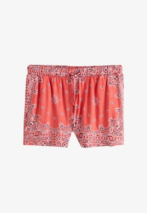 Pantaloni scurți roșii cu șnur și talie elastică, având un model de bandană paisley și floral în alb și negru.