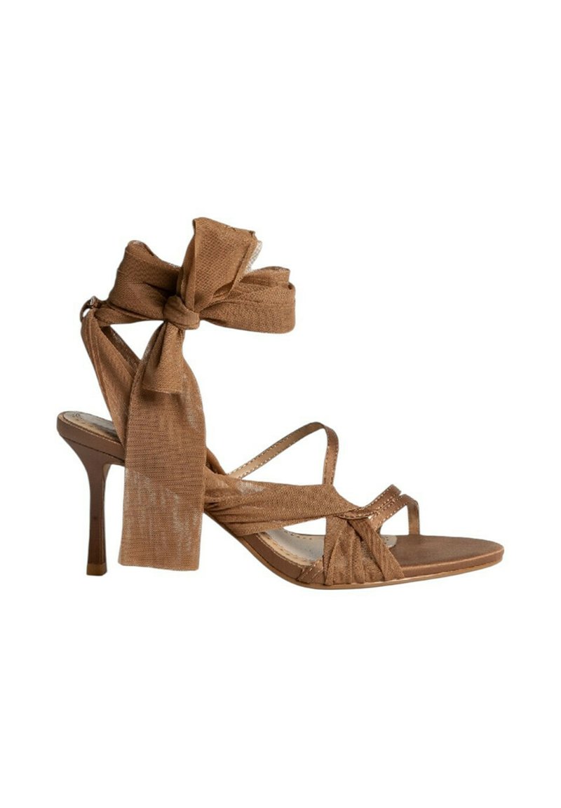 Sandalia de tacón alto marrón con un acento de lazo de tela texturizada, tiras entrelazadas y un tacón delgado y afilado. Planta suave con punta abierta.