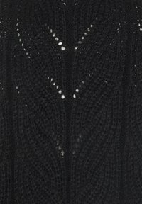 Sort strikket sweater med et struktureret mønster, der har skiftende diagonale linjer og små åbninger for åndbarhed.