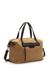Tan fabric handbag with black leather accents, featuring two top handles, a detachable shoulder strap, and a front zip pocket.