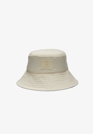 Beige Bucket Hat aus Baumwolle mit strukturiertem Finish. Verfügt über ein gesticktes Band und ein quadratisches Logopatch auf der Vorderseite.