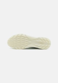 Sko såle med en teksturert, mønstret design i lys beige. Har dype spor for grep. Glatte kanter med en avrundet form.