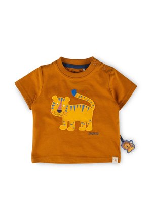 Kleinkindshirt in Rostfarbe mit blau gestreiftem, gelbem Tiger-Applikation und einem kleinen, löwenförmigen Etikett an der Seite.