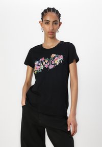 Black t-shirt with a floral design in pink, yellow, and green, featuring the text "LIU JO" in the center. Short sleeves and relaxed fit.