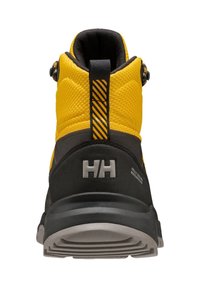 Bottes de randonnée jaunes et noires en mesh texturé et matériaux en caoutchouc. Présentent un logo visible, un renfort au talon et une semelle robuste.