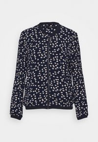 Marinblå zip-up jacka med små vita och gula blommönster, ribbade muddar och fåll, långa ärmar och rund halsringning.