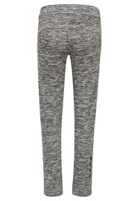 Grijze melange legging met een gladde textuur, getailleerde vorm en een chevronaccent aan de onderkant. Voorzien van een middelhoge tailleband.