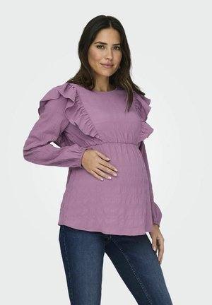 Lavender maternity top with ruffled sleeves, textured fabric, and gathered waist. Paired with dark denim jeans, worn by a model.