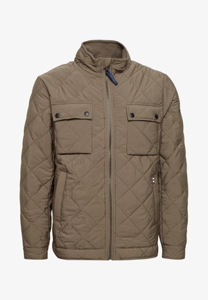 Tűzött barna dzseki magas gallérral, két mellső zsebbel, patentzárral, oldalsó zsebekkel és elülső cipzárral. Jellemzője a strukturált anyag.