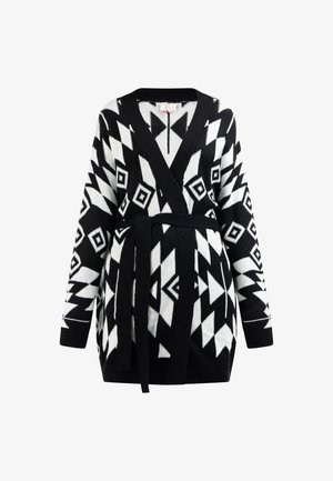 Black and white geometric-patterned cardigan with long sleeves, wrap design, and a matching tie belt. Knit texture with a cozy appearance.