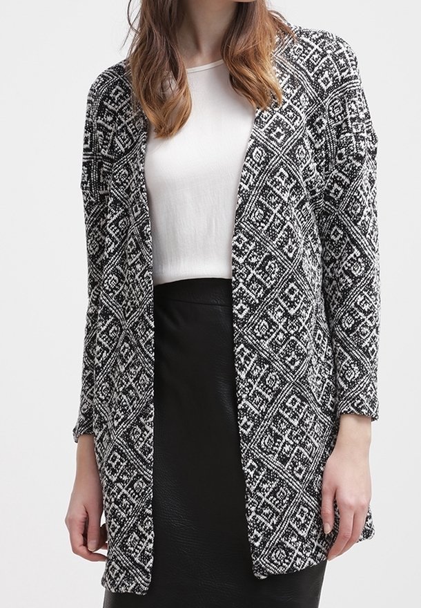 Czarny i biały kardigan w wzory z długimi rękawami i otwartym przodem. Tekstura dzianiny zawiera geometryczne wzory i luźny krój.