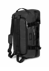 Czarny plecak z trwałego nylonu, prostokątny kształt, regulowane paski na ramiona oraz liczne kieszenie zapinane na zip. Posiada regulowane paski.