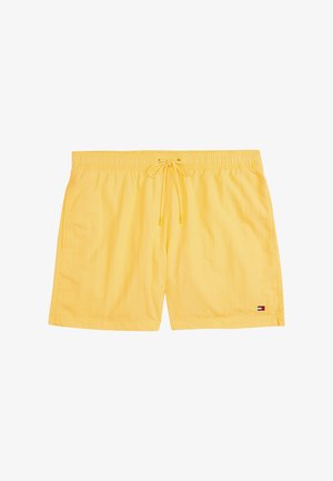 Dzeltenie peldēšanas šorti, izgatavoti no viegla auduma, ar elastīgu jostasvietu un auklu, kā arī sānu kabatām; zīmola logotipa detaļa apakšā.