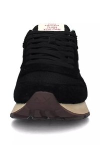 Scarpa da ginnastica nera in suede e rete, con suola in gomma, lacci piatti e una linguetta con la scritta "CORRI PIÙ VELOCE DI QUANTO PUOI" in testo rosso.