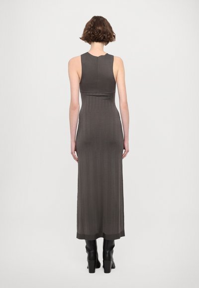 Long, fitted dress in dark gray ribbed fabric, featuring a sleeveless design and a high neckline. Smooth texture with a subtle sheen.