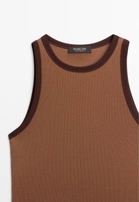 Brown tank top with a ribbed texture, featuring a rounded neckline and dark brown trim. Label reads “Massimo Dutti, made in Portugal.”