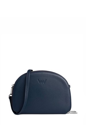 Navy leather crossbody bag with rounded shape, textured finish, zip closure, and an embossed logo on the front. Adjustable strap included.