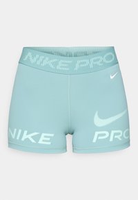 Light blue women's shorts made of stretchy fabric, featuring a wide waistband with "NIKE PRO" text and logo in white.