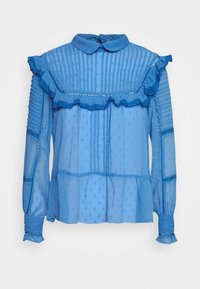 Vaaleansininen pusero, jossa on rypytetty kaulus ja hihansuut, näyttävässä kankaassa on pystysuoria raitoja ja pistekuvioita. Pitkät hihat, löysä istuvuus.