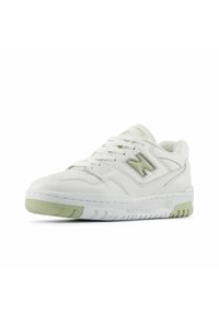 White leather sneaker with a perforated design and light green accents. Features flat laces, padded collar, and a textured rubber sole.