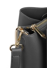 Gray leather handbag featuring a zippered top, gold hardware, and a detachable strap with a trigger clip. Smooth texture and minimalistic design.