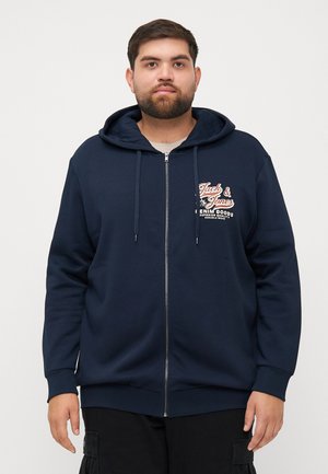 Marineblauer Zip-Hoodie aus weichem Material mit einem grafischen Logo auf der Vorderseite, Kordelzugkapuze und gerippten Bündchen und Saum. Klassischer, lässiger Schnitt.