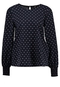 Blusa navy con un motivo a rombi in bianco e rosso. Presenta maniche lunghe a sbuffo con polsini arricciati e un dettaglio a chiave sul retro.