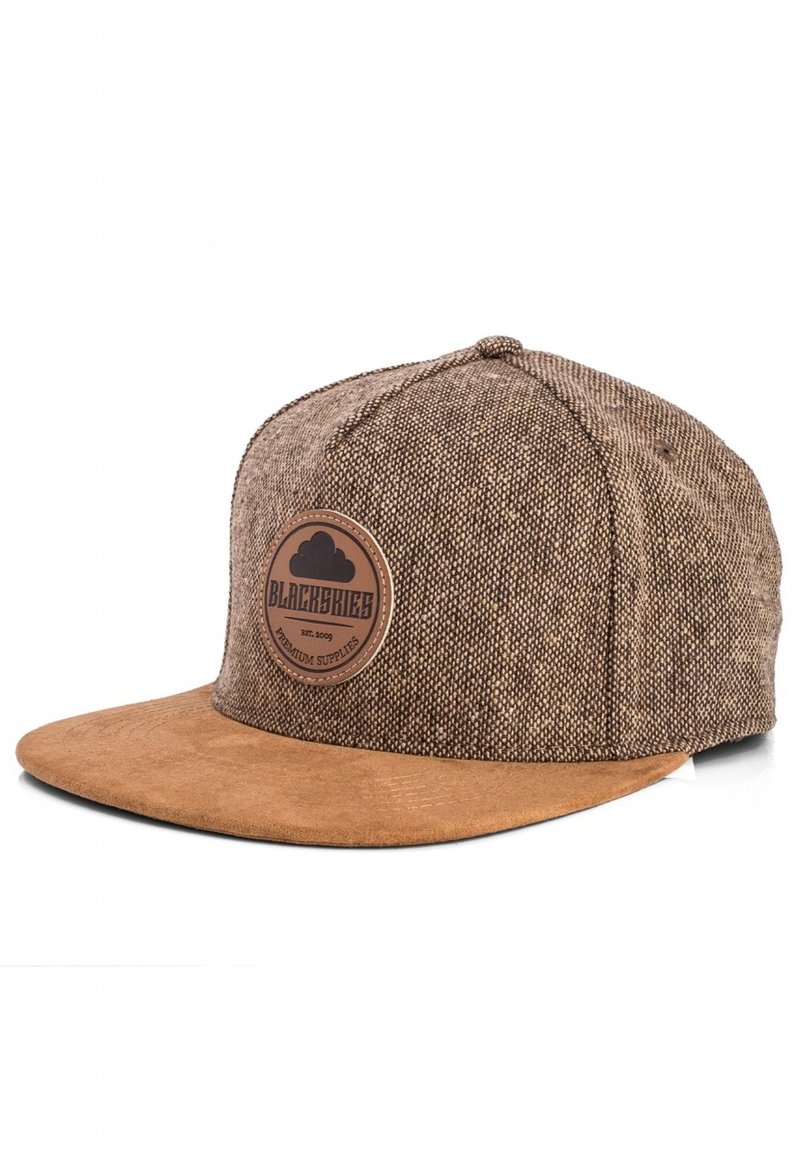 Brown fabric snapback cap with a suede brim. Features a circular leather patch labeled "BLACKSKIES" and a textured woven pattern.