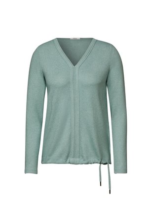 Mint grøn langærmet top med v-hals, snor i taljen og struktureret strikket stof. Har en central sømdetalje foran.