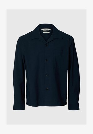 Tengerészkék rövid ujjú ing, galléros kialakítás, elöl gombos zárral és egy mellzsebbel. Könnyű, sima anyagból készült.