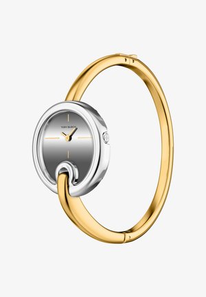 Sølv- og guldbangle ur med en rundet grå urskive. Har gule time- og minutvisere, minimalistisk design og en poleret metalfinish.