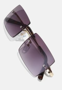 Square sunglasses with dark purple lenses, gold accents, and a tortoiseshell frame. Features a nose pad and hinge details.