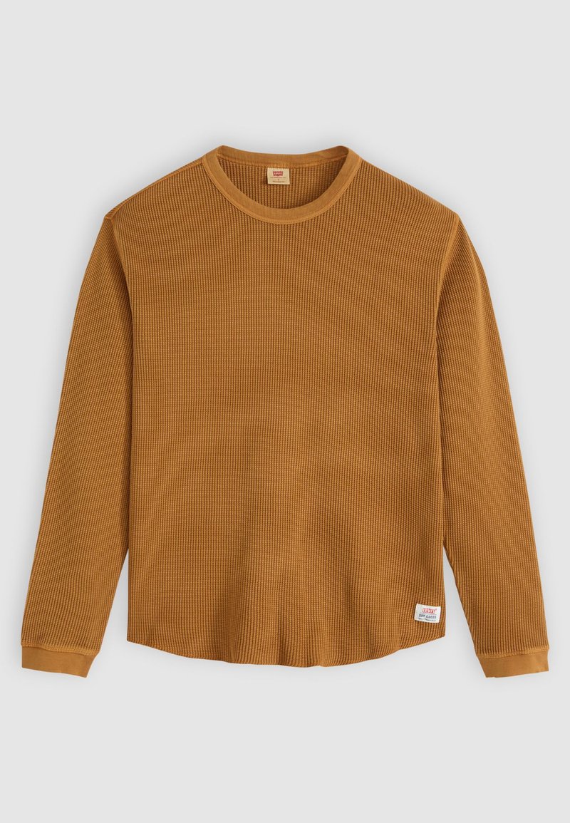 Langärmliges, senfgelbes Thermoshirt mit strukturiertem Rippdesign, runder Ausschnitt und einem kleinen Markenzeichen am unteren Saum.
