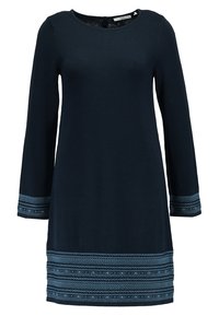 Robe bleu marine à manches longues avec un col rond, ornée d'un bord à motifs géométriques bleu clair sur les poignets et l'ourlet.