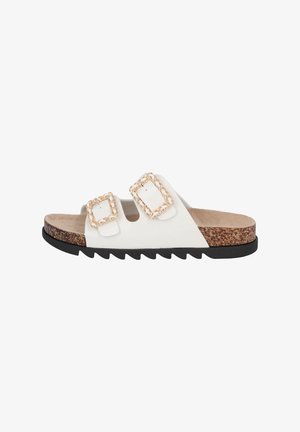 Sandale blanche à glissière avec deux boucles carrées, semelle en liège et semelle extérieure en caoutchouc noir avec un motif en zigzag.