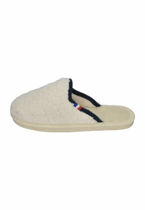 Cream-colored slipper made of plush material with a textured surface, black trim, and a small French flag accent on the side.