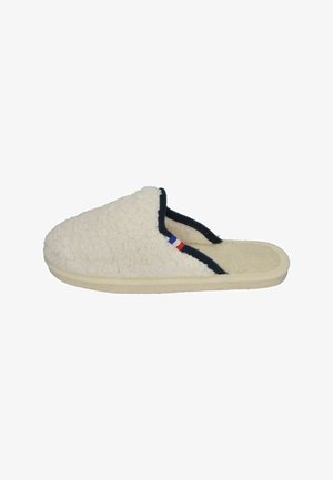 Cream-colored slipper made of plush material with a textured surface, black trim, and a small French flag accent on the side.