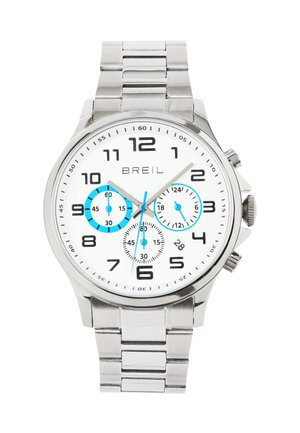 Sølv rustfrit stål ur med hvid urskive, sorte tal og blå underdials. Har en chronograf-funktion og et link-armbånd.