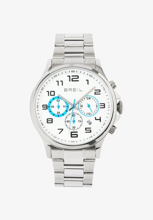 Sølv rustfrit stål ur med hvid urskive, sorte tal og blå underdials. Har en chronograf-funktion og et link-armbånd.