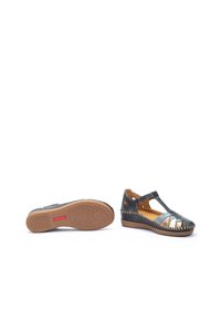 Sandali a zeppa in pelle nera con design a T, dettagli intagliati e suola in gomma testurizzata con una grip a motivo. Flessibili e traspiranti.