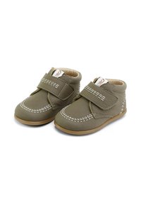 Zapatos de cuero verdes para niños pequeños con una textura suave, correa de Velcro, detalle de costura blanca y suela de goma marrón. Diseño de tobillo bajo.