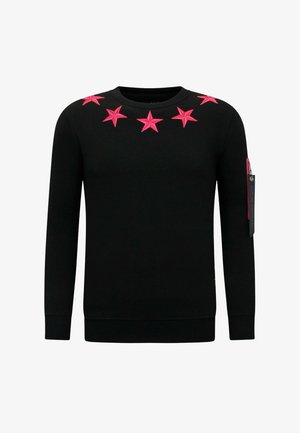 Zwarte trui met felroze stervormige versieringen op de borst, een ronde hals en een ritssluiting op de mouw.