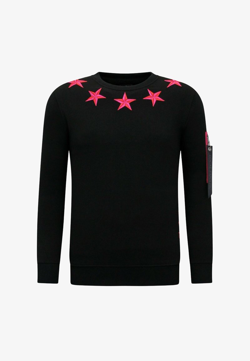 Zwarte trui met felroze stervormige versieringen op de borst, een ronde hals en een ritssluiting op de mouw.