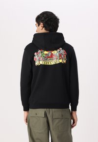 Black hoodie with a large, colorful graphic on the back featuring skeletons and the text "SANTA CRUZ." Cotton material, standard fit, drawstring hood.