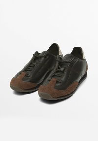 Brown leather shoes with textured brown suede accents, lace-up design, rounded toe, and a low-profile sole.