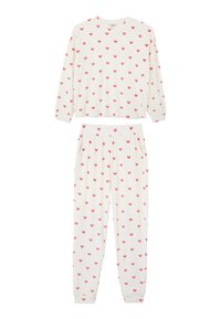Valkoinen pyjama, joka sisältää pitkähihnaisen paidan ja housut, molemmissa on punainen sydänkuvio. Pehmeä kangas, jossa joustava vyötärönauha ja taskut.