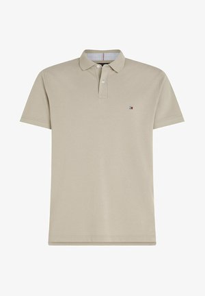 Polo shirt beige à manches courtes avec deux boutons et petit logo en forme de drapeau rectangulaire sur le côté gauche de la poitrine.