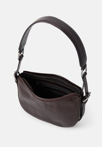 Brown leather shoulder bag with a smooth texture, a wide strap, and a zippered interior with multiple compartments.