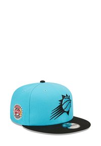 Turquoise baseball cap with a black brim, featuring a black sun logo and a colorful PHX badge on the side. Cotton material, structured design.