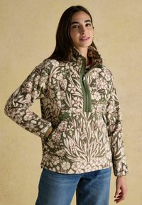 Fleece mikina s květinovým vzorem v zelené a krémové barvě, s vysokým límcem, půlzipem vpředu a bočními kapsami. Měkká textura a volný střih.